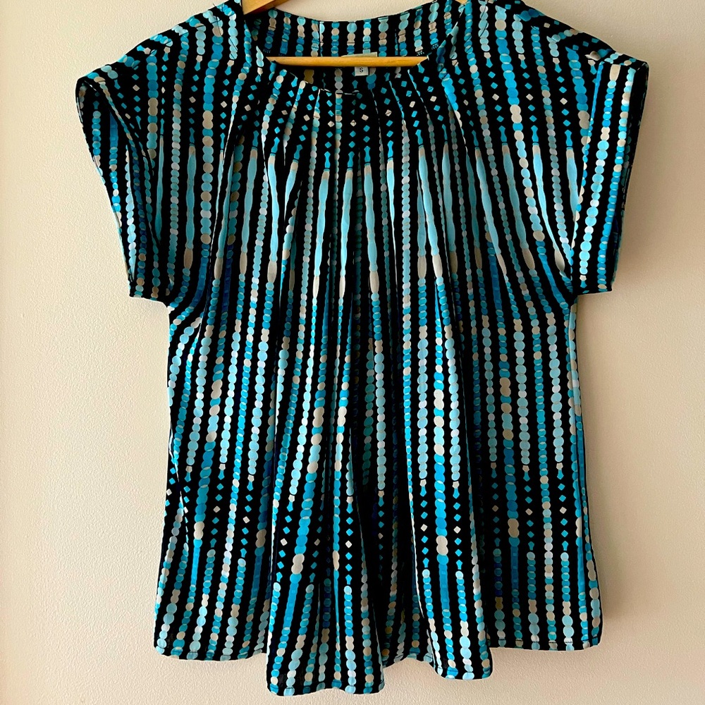 This top is blue with a baby blue include and white and black.